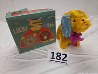 Wind-up dog beside original Lucky Pet box