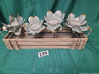 Planter front view showing wood crate and four metal flower holders