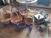 Group view of wicker baskets and metal items on floor