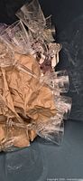 clear stemmed glasses packed in bin with paper