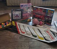 All items laid out showing board game, craft kits, cups, posters, novelty items