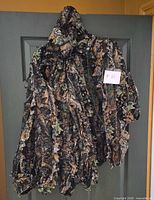 Jacket hanging to show hood, zip front and leafy camo texture