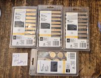 Four sealed packages: three 10-pack bar pulls, one 10-pack round knobs