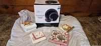 Mainstays dinnerware set box with four packs of new napkins arranged around it