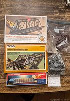 Boxed bridge and trestle sets plus bag of supports on tabletop