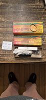 Two boxed HO-scale kit packages plus one opened box showing black tank car parts