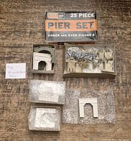 Box marked Atlas 25 Piece Pier Set with contents shown, including plastic pier parts, some wrapped in bubble wrap
