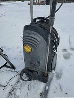 Front view of Karcher electric pressure washer standing on snow