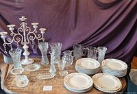 Full view of table showing candelabra, crystal pieces and plate stacks