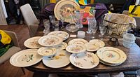 Overall view of lot on table showing plates, glassware, basket