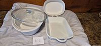 All three white ceramic baking dishes displayed: round casserole with lid, oval baker, rectangular baker