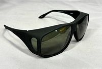 Front angle of black Haven slip-over sunglasses showing wraparound frame and tinted lenses
