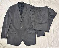 Full view of jacket and trousers laid flat