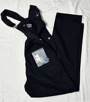 Overalls folded showing tag and front bib pocket