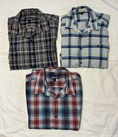 Three folded Patagonia plaid shirts