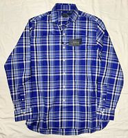 Full view of blue and white plaid long sleeve button-down shirt laid flat