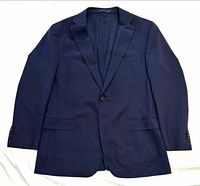 Front view of navy blazer with single-breasted two-button closure and flap pockets