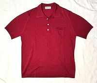 Full view of dark red Montagut short-sleeve polo shirt laid flat