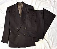 Suit jacket and trousers laid flat showing full set