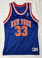 Front view of blue Knicks jersey with NEW YORK 33 and Champion tag