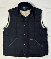 Front view of black down vest with corduroy collar