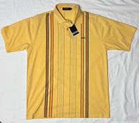 Full frontal view of the yellow Hugo Boss polo laid flat showing overall design and stripes