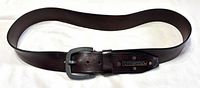 Full view of brown leather belt laid flat showing buckle and overall length
