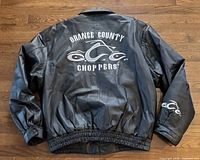 Back view of black leather jacket with large Orange County Choppers logo