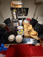 Overview of all kitchen items on table including air fryer, plates, scale, bowls and accessories