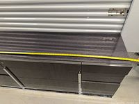 Full length top and front of credenza with tape showing width