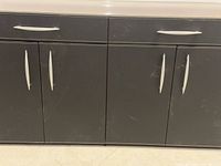 Front view of cabinet showing drawers, doors, handles, stitching detail