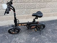 Full side view of black Rizz folding e-bike showing frame, wheels, saddle, handlebars