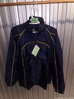 Front of navy windbreaker with yellow piping and tag visible