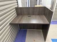 Front angle showing desk surface, privacy panels, cable grommet