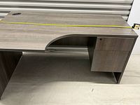 Top view of entire desk showing curved cutout and pedestal