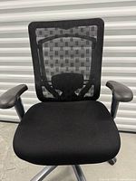 Front view showing mesh back, fabric seat, armrests, base