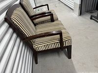 Side view of both striped upholstery chairs against storage unit