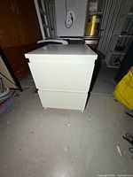 Front and side view of white two-drawer nightstand