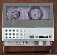 Top view of Aiwa reel-to-reel tape recorder showing reels and carry handle