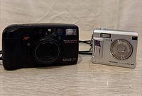 Front view of Minolta Riva 100AF and Fujifilm FinePix F440 cameras side by side