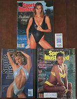 Three Sports Illustrated Swimsuit magazines laid out: 1988 Elle Macpherson, 1989 25th Anniversary Kathy Ireland, 1993 Vendela