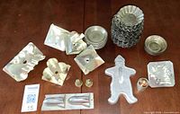 Entire lot laid out showing diverse tin bakeware pieces