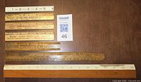 All seven rulers laid out showing front scales and advertising