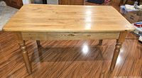 Full view of rectangular pine table on hardwood floor
