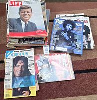 Stack of assorted magazines with Life JFK top, Rolling Stone Hendrix, Circus Alice Cooper, People visible