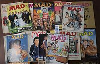 Overview of all 25 MAD magazines spread out, multiple cover themes visible