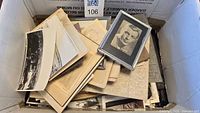 Cardboard box filled with loose photographs, photo albums and small framed image