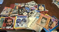 Overhead view of assorted magazines, catalogues, programmes and brochures showing quantity and variety