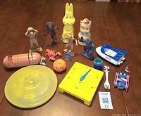 Group shot of all sixteen plastic toys displayed on table