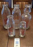 Group shot of all five milk bottles front view